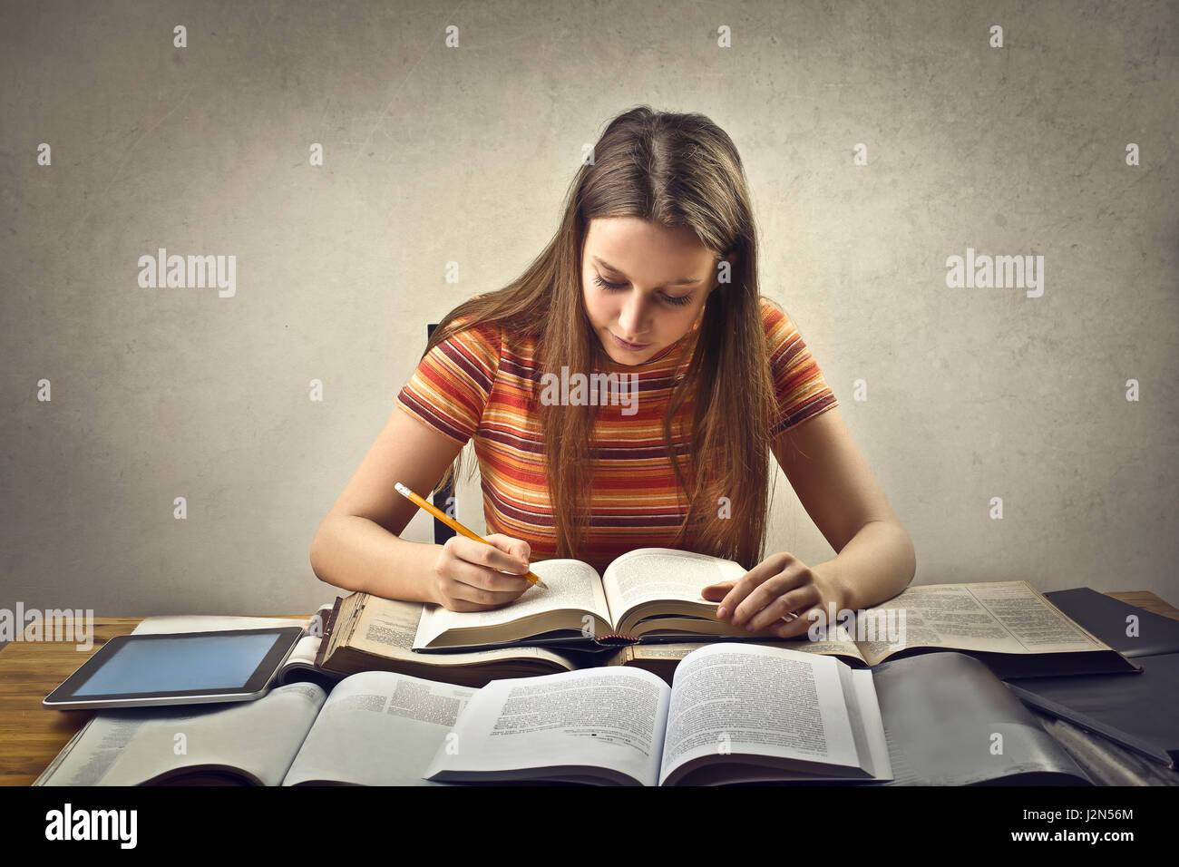 Young woman studying at table Stock Photo - Alamy