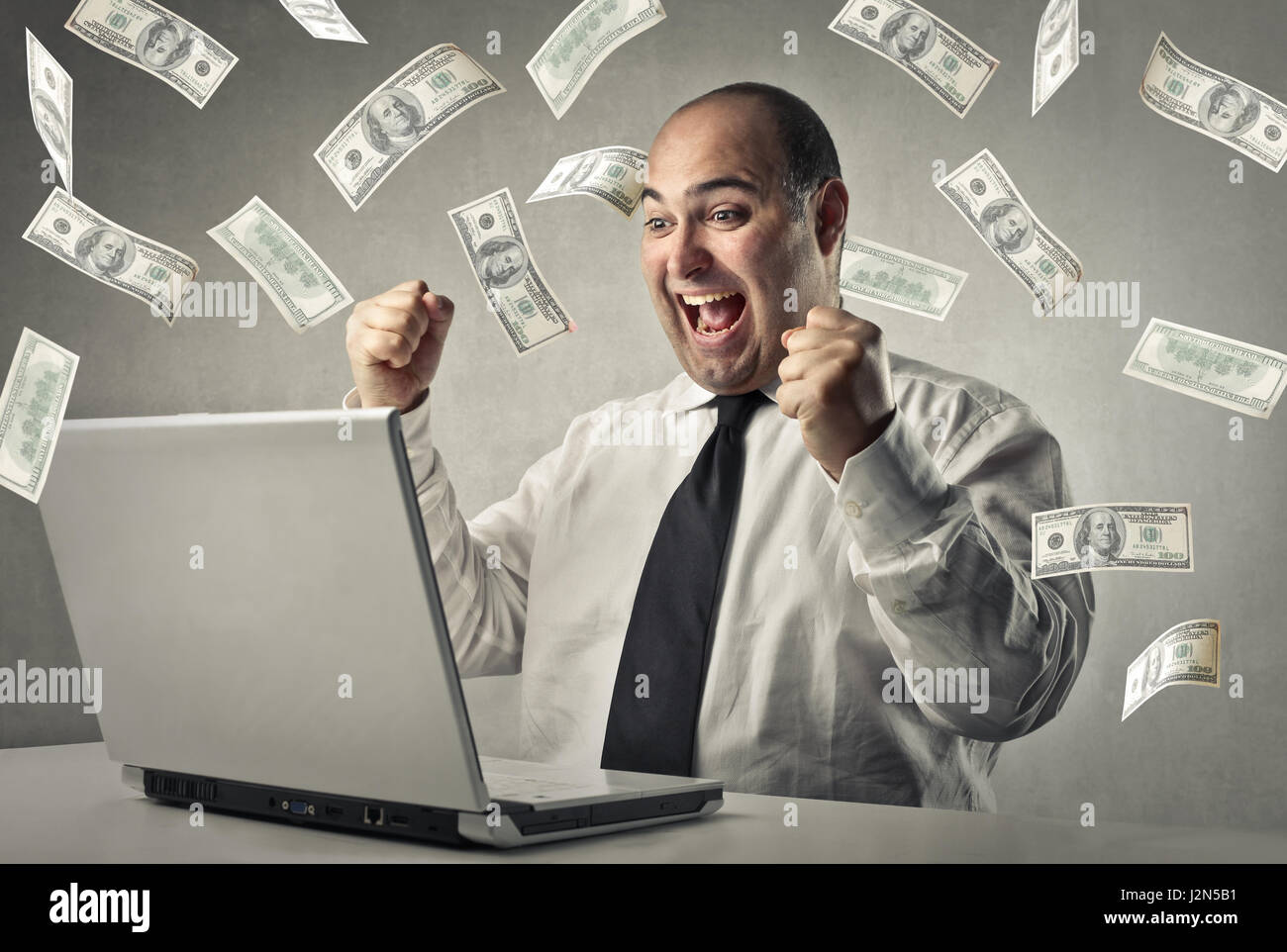 Happy businessman with dollar shower Stock Photo