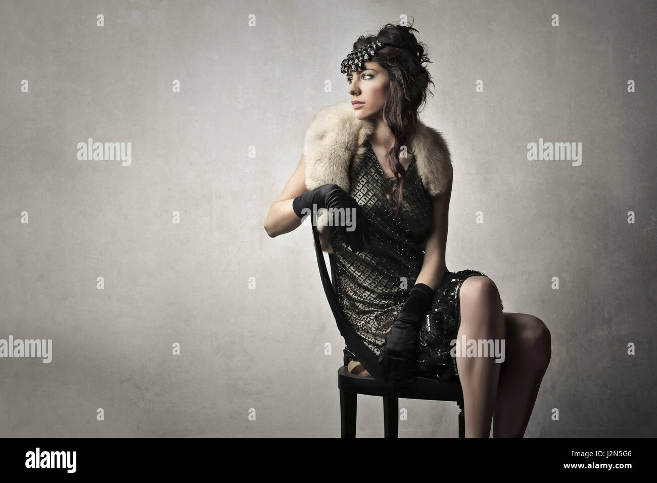 Elegant woman sitting on chair Stock Photo