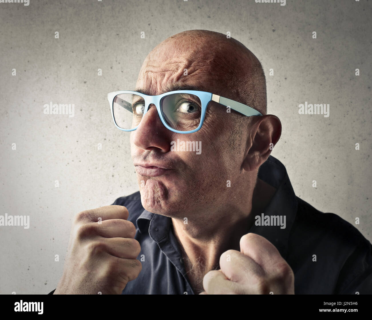 Bald man being agressive Stock Photo