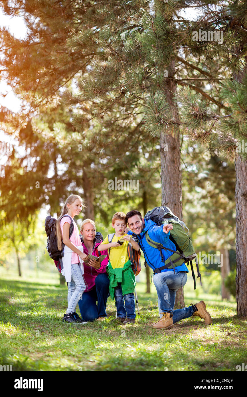 Happy parents hiking with their child in forest Stock Photo - Alamy