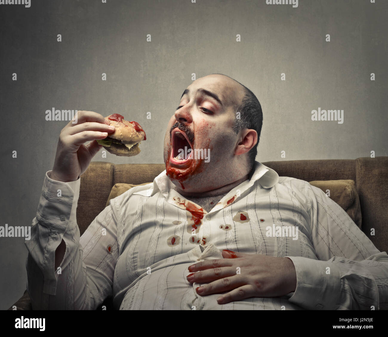 Obese Man Eating Hamburger Stock Photo Alamy