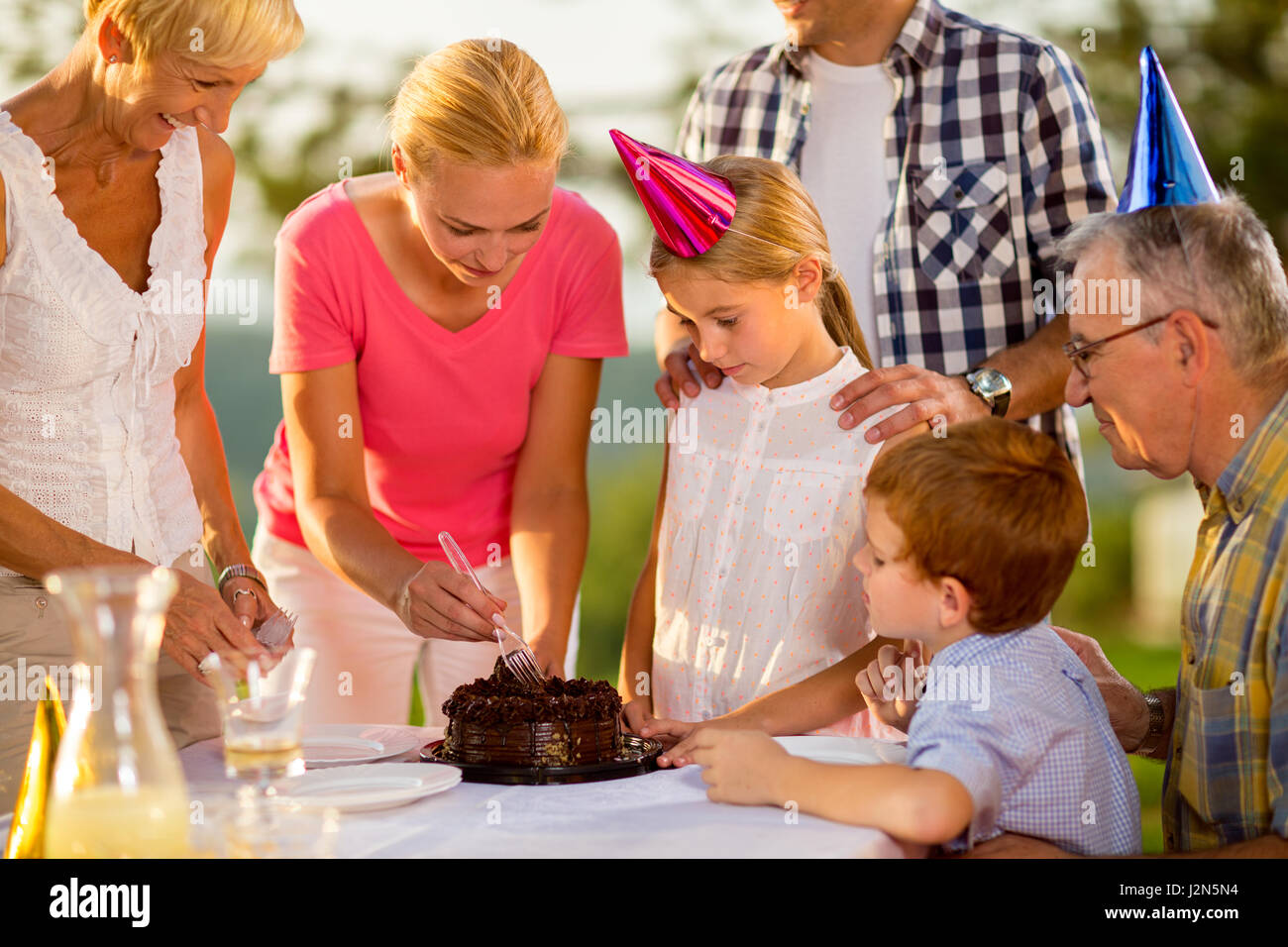 Family eating the birthday cake together Stock Photo