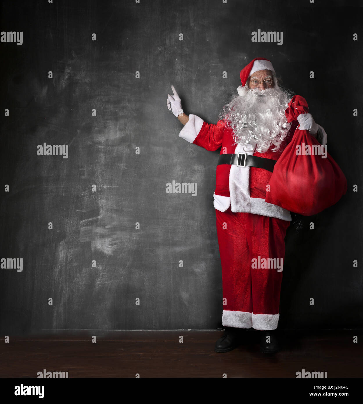 Santa Claus in front of blackboard Stock Photo - Alamy