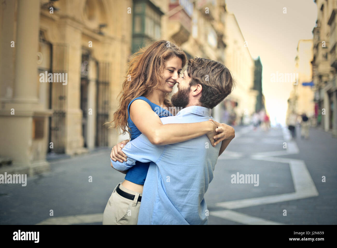 Young couple hugging on the street Stock Photo