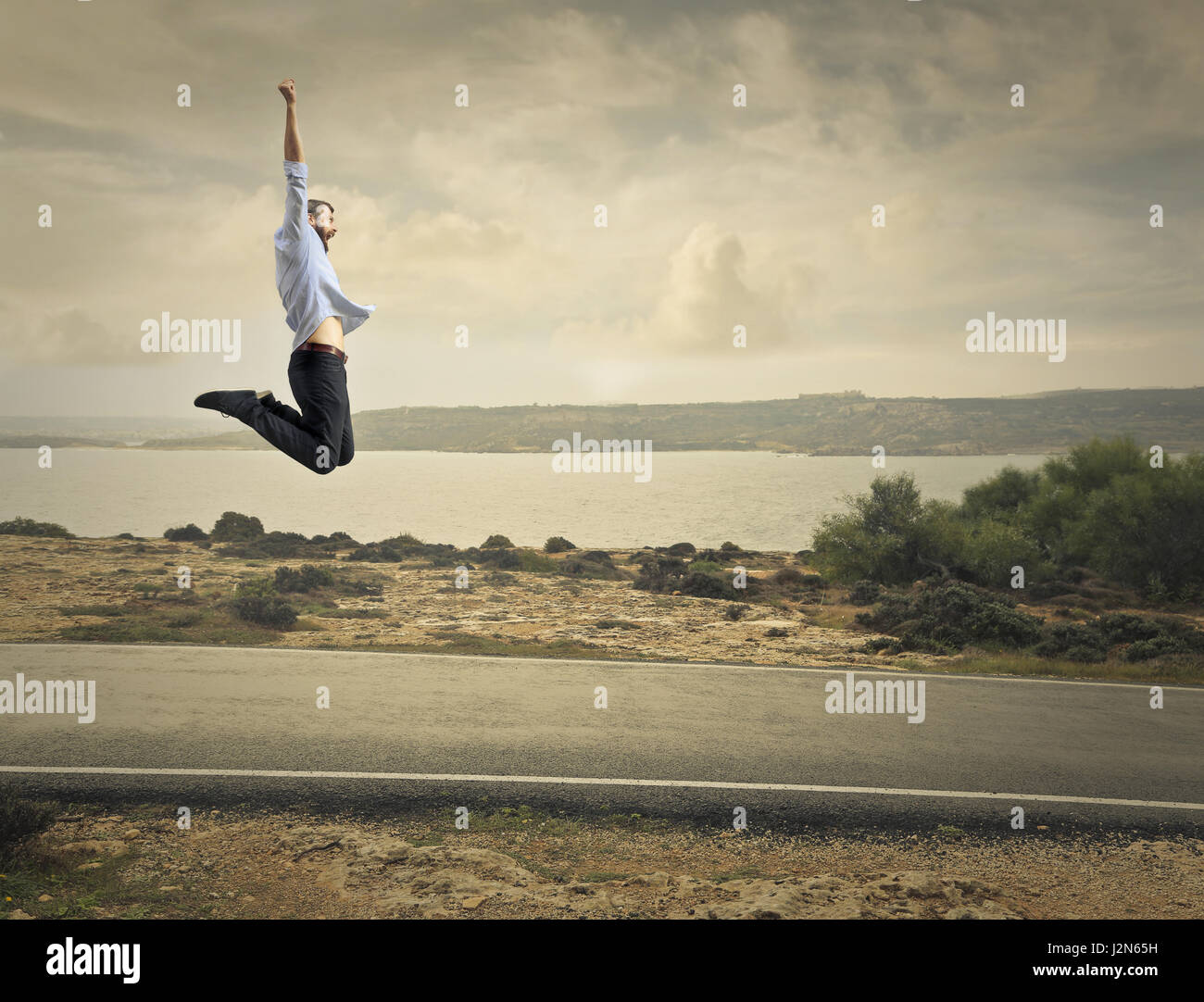 Free man jumping on highway Stock Photo