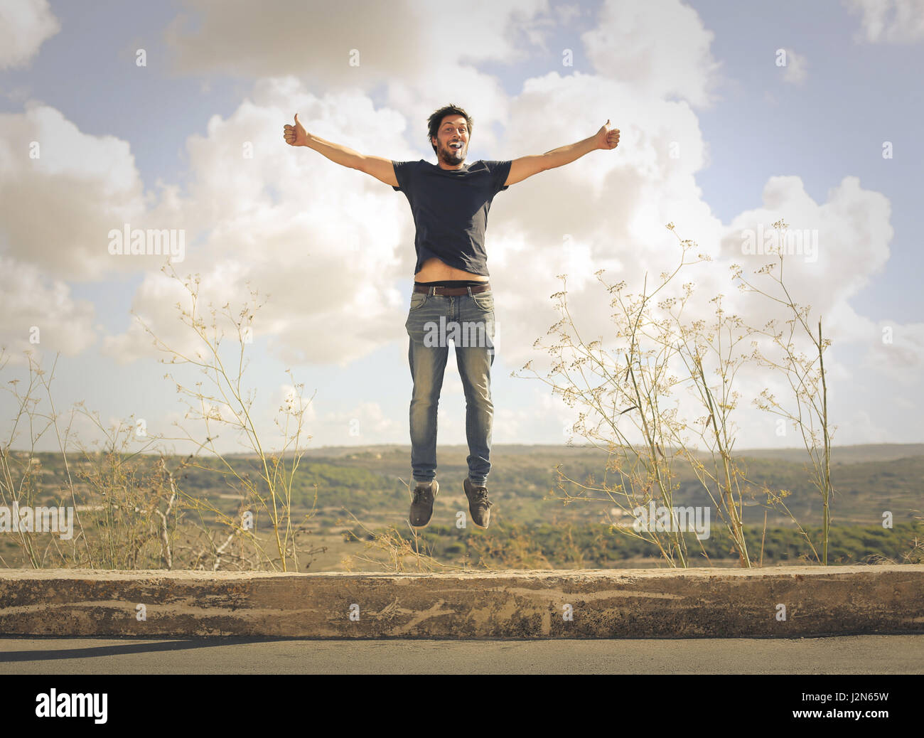 Man jumping on field Stock Photo