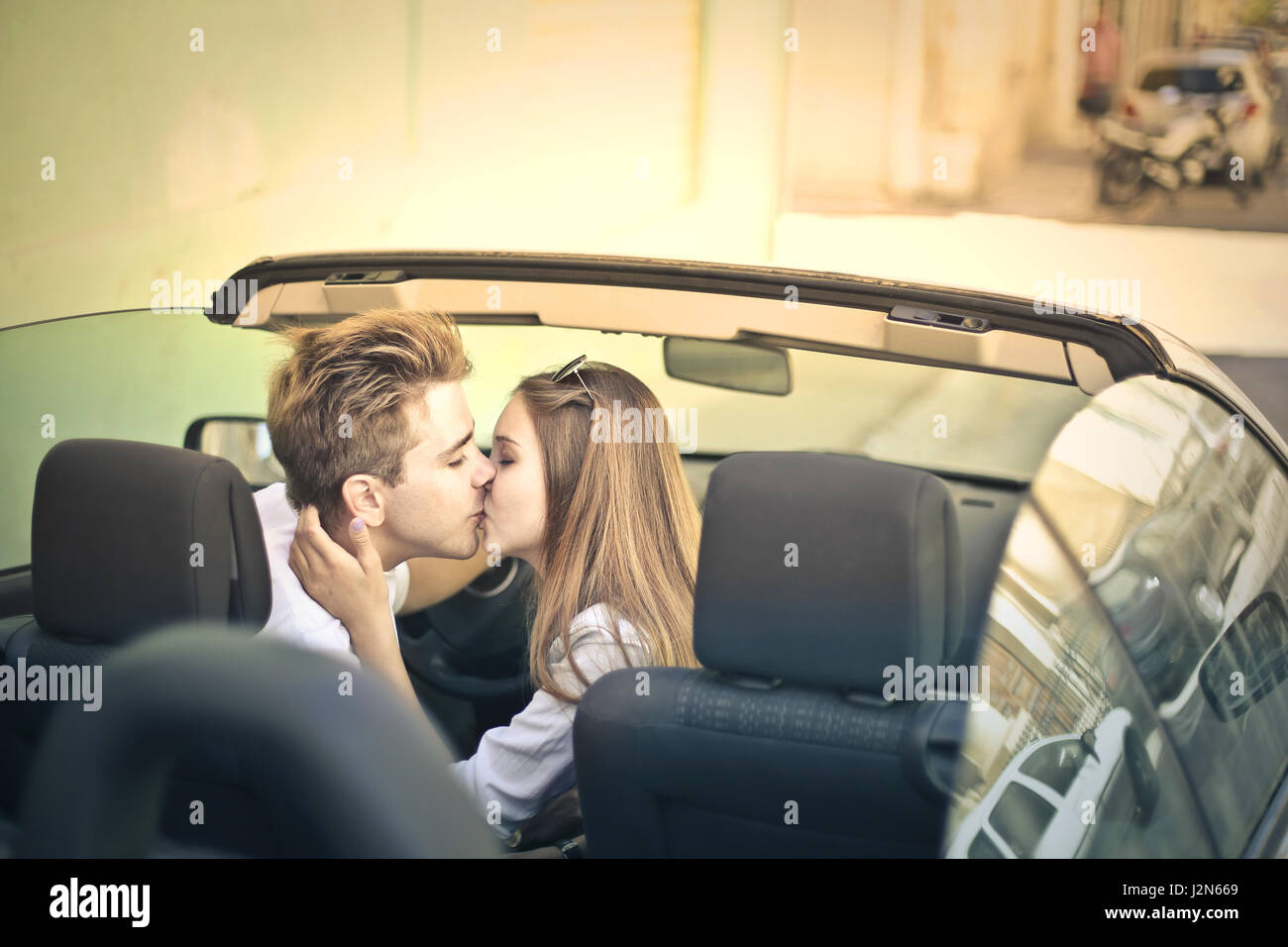 Young couple kissing in car Stock Photo