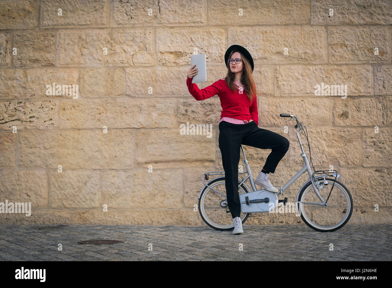 Woman with bike taking a selfie with tablet Stock Photo Alamy
