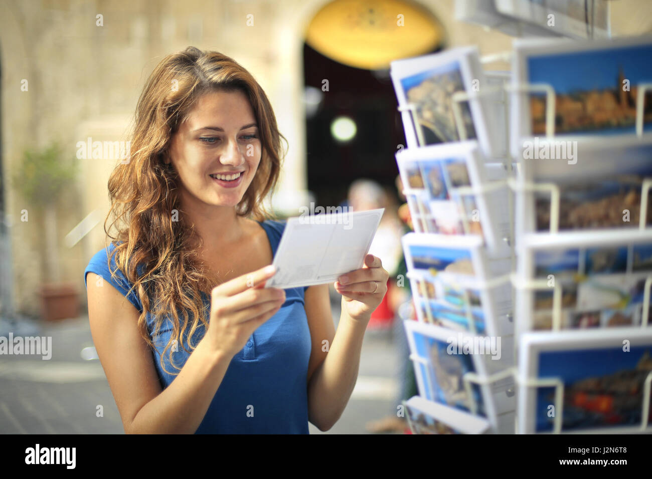 Woman looking at postcards Stock Photo