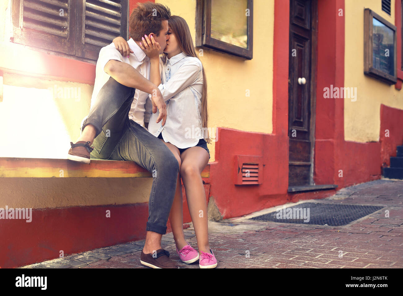 Young couple kissing outside Stock Photo