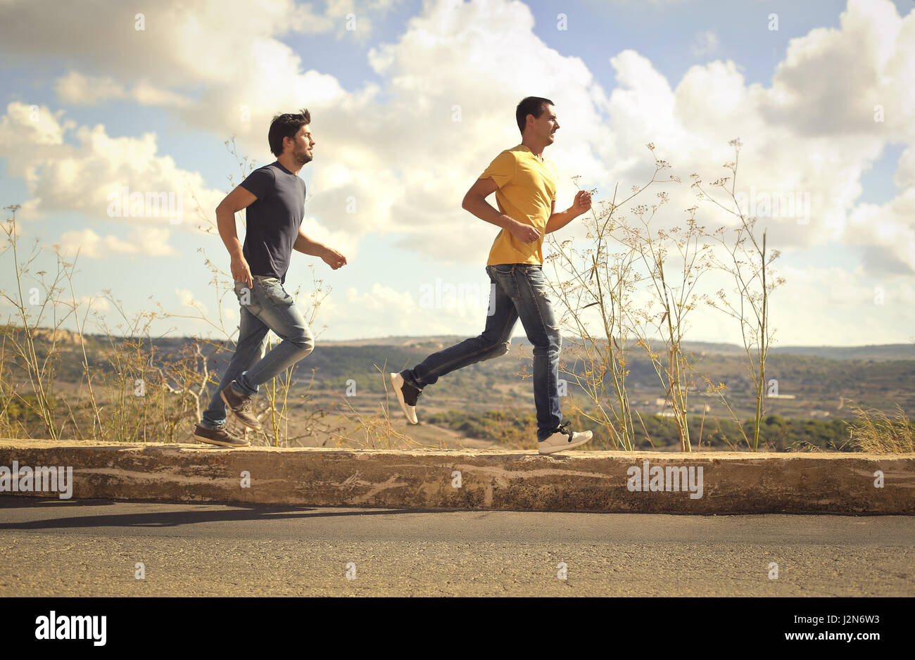 2 men running outside Stock Photo