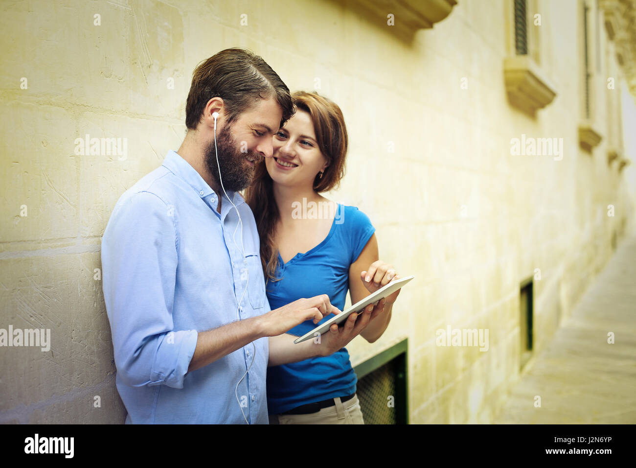 Man with tablet and woman on street Stock Photo
