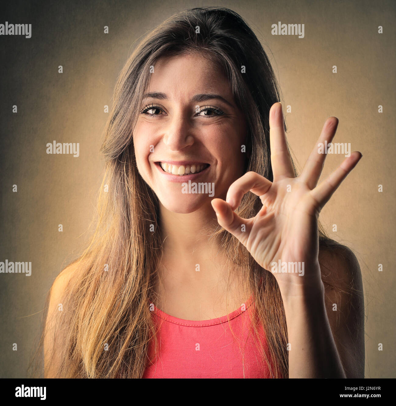 Brunette woman showing perfect sign Stock Photo