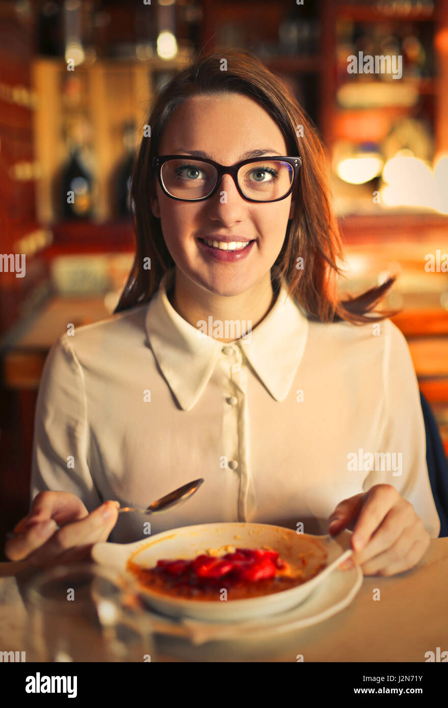 Woman eating inside Stock Photo