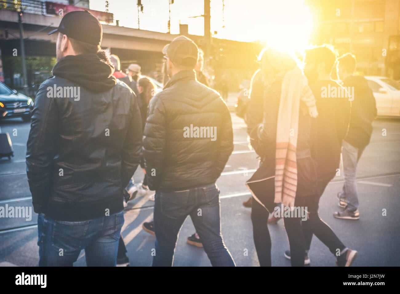 group of young people walking on street - friends crossing street together Stock Photo