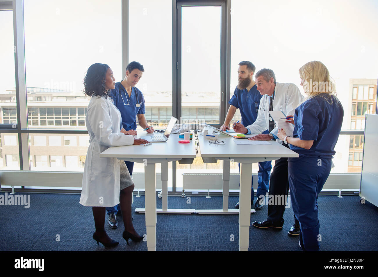 Team of doctors communicating during meeting in a hospital. Multi ethnic medical team Stock Photo