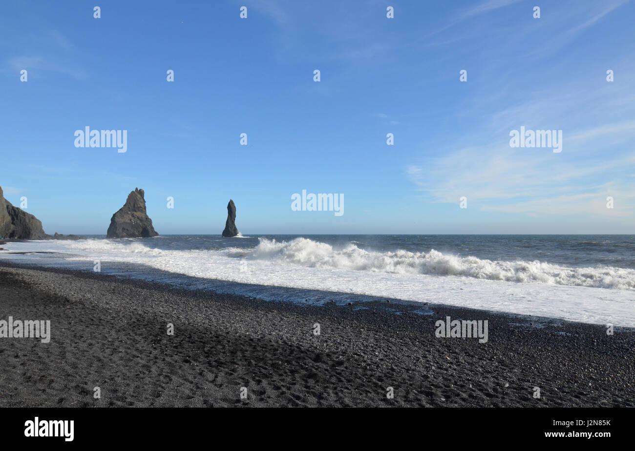 Reynisdrangar sea stack on black sand beach in Vik Iceland Stock Photo ...
