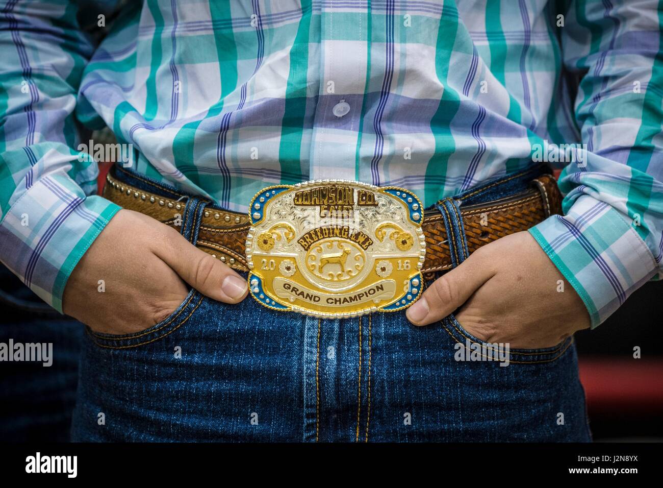 A young boy shows off prize Grand Champion buckle for sheep breeding during the American Royal annual livestock show and rodeo at the Kemper Arena April 28, 2017 in Kansas City, Missouri. Stock Photo