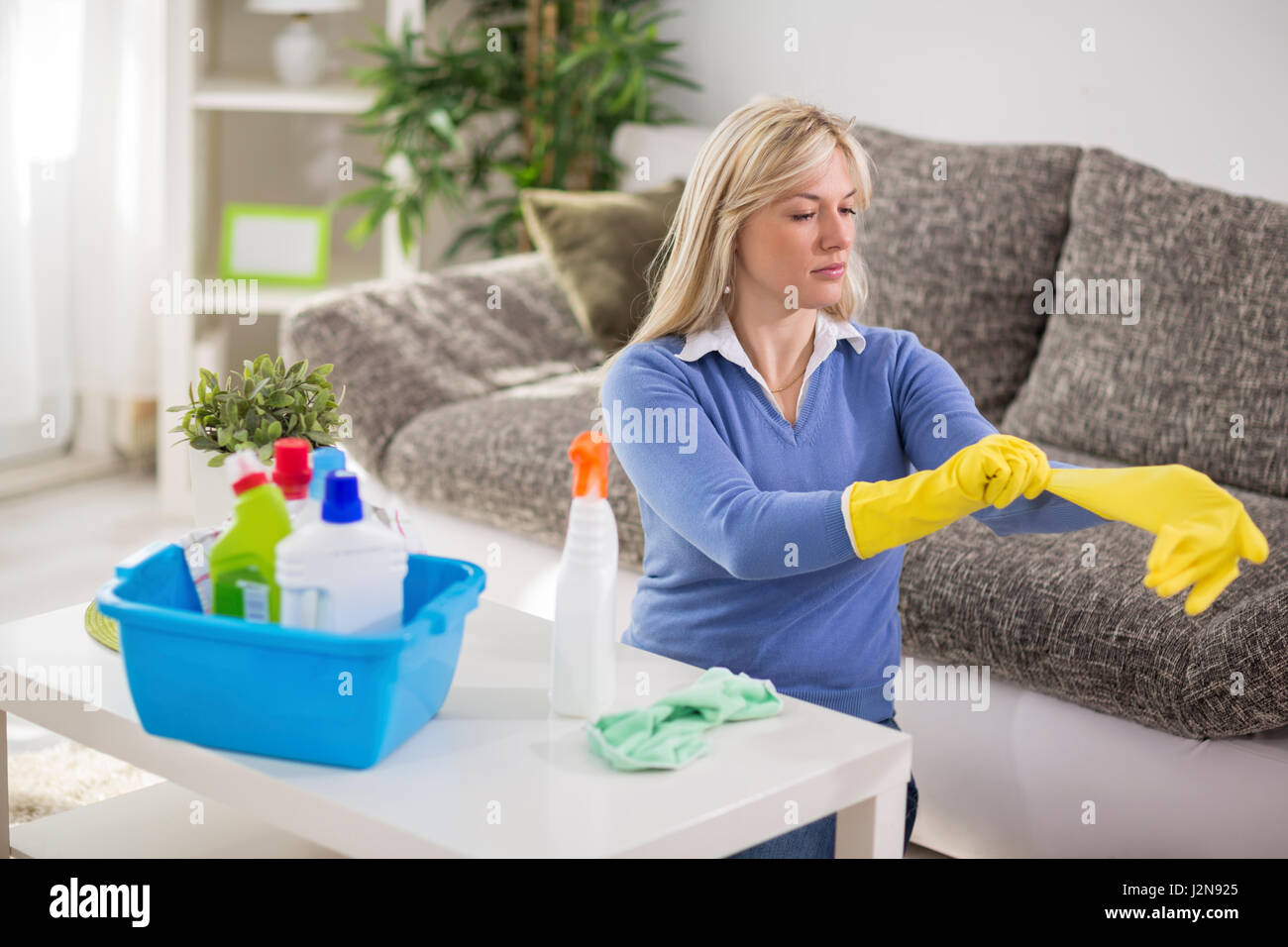 Young woman from cleaning service cleans house Stock Photo