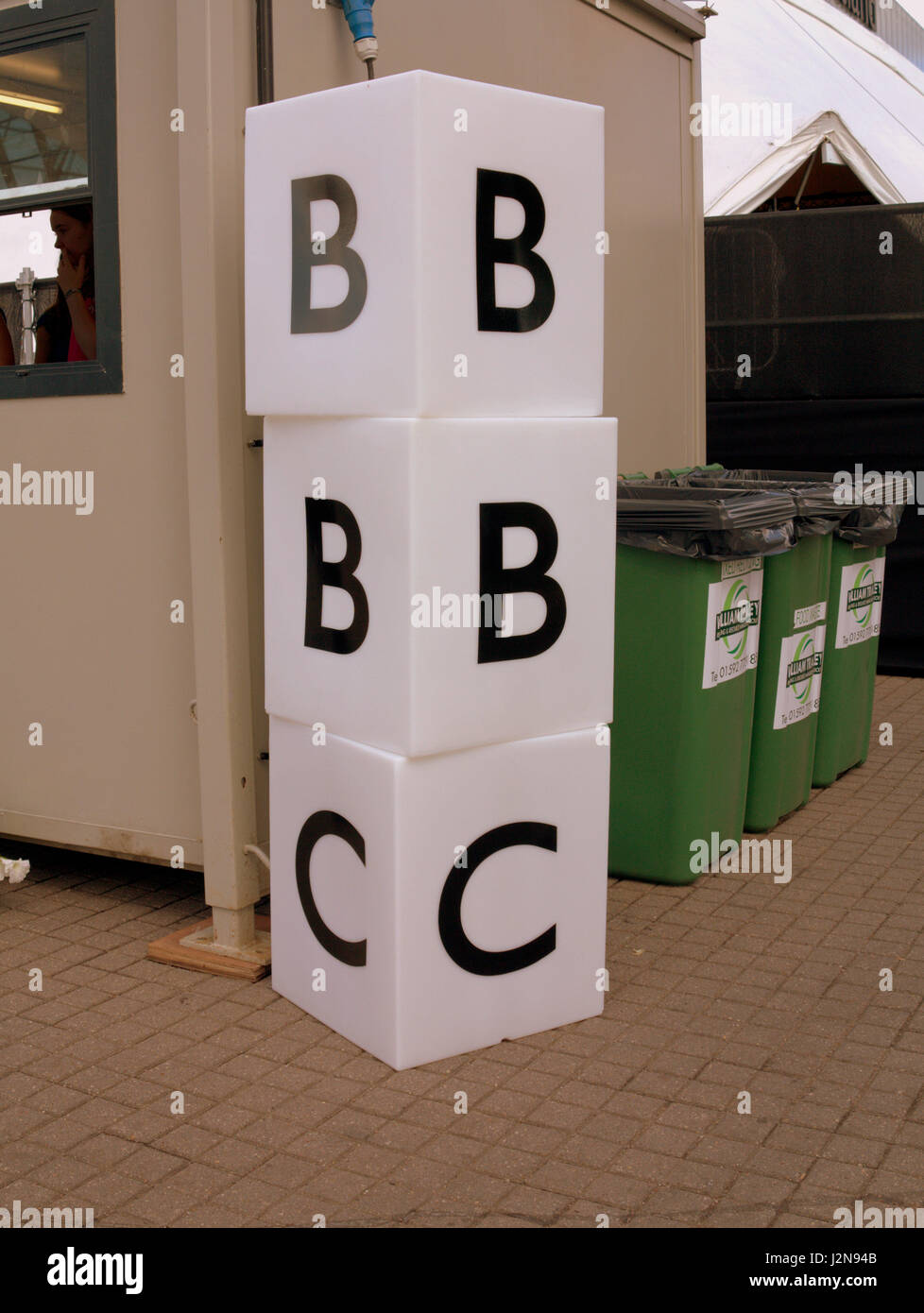 BBC logo in building blocks beside rubbish bins outside BBC Scotland Glasgow Stock Photo