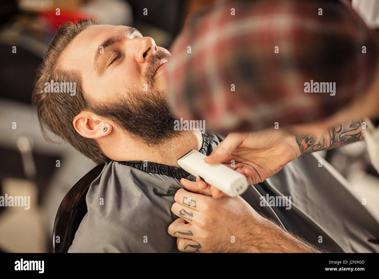 professional grooming of real man in barbershop Stock Photo
