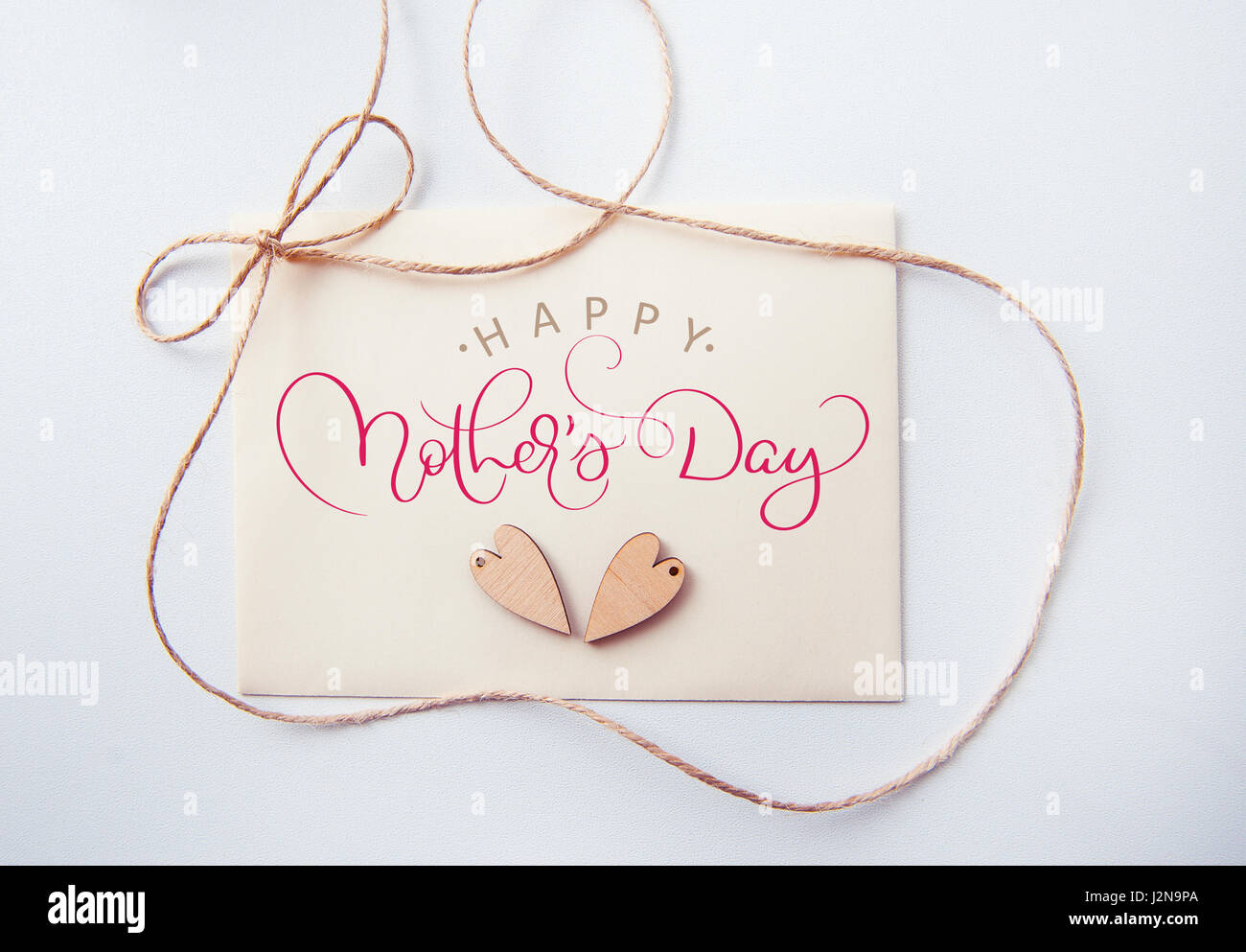 Holidays card with wooden heart and text Happy mothers day. Calligraphy lettering hand draw Stock Photo