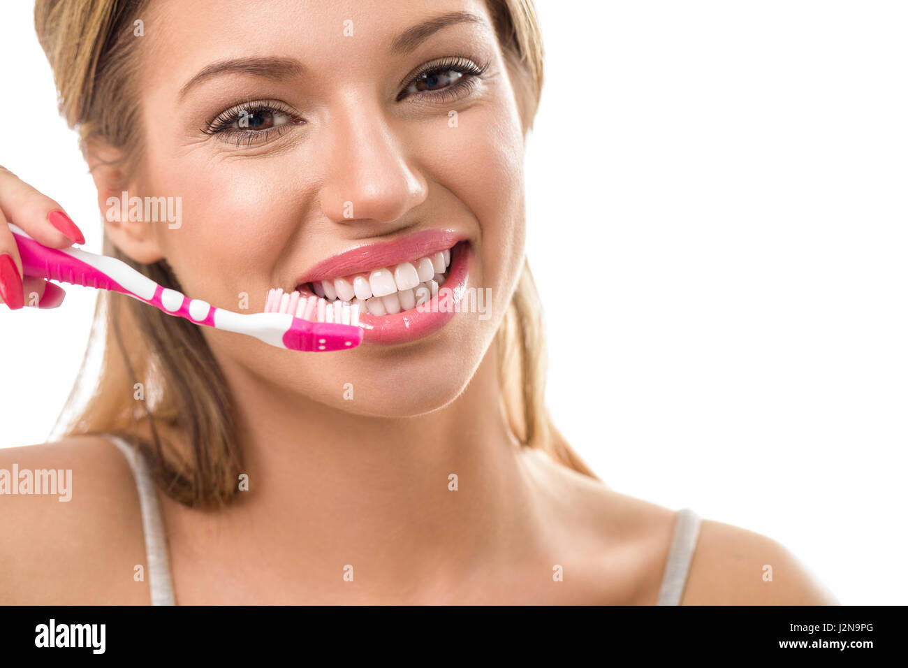 Smiling young woman during brushing teeth, dental hygiene Stock Photo