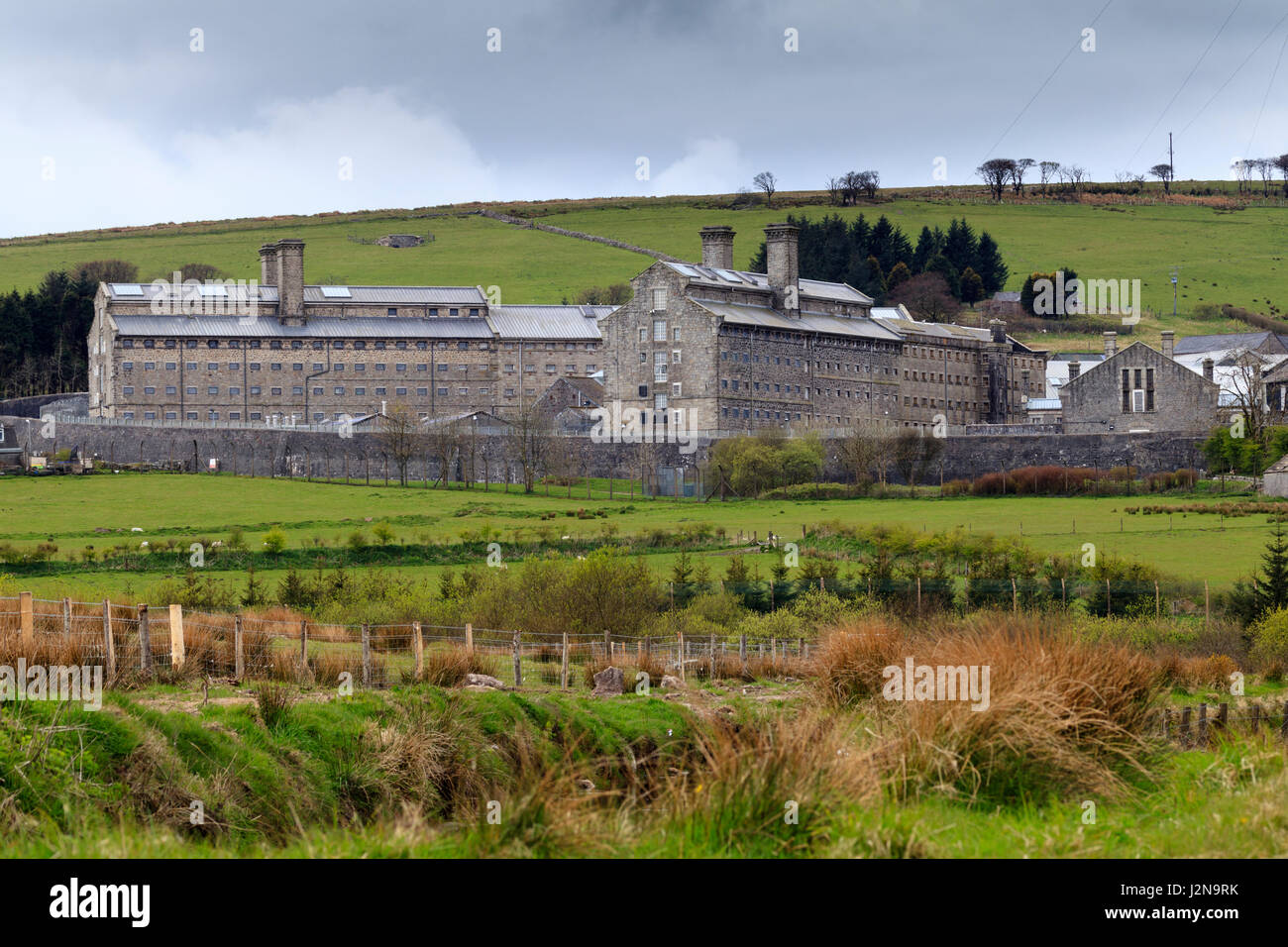 View across the moor of Her Majesty's Prison, Dartmoor, Princetown, Devon, on a cloudy April day Stock Photo