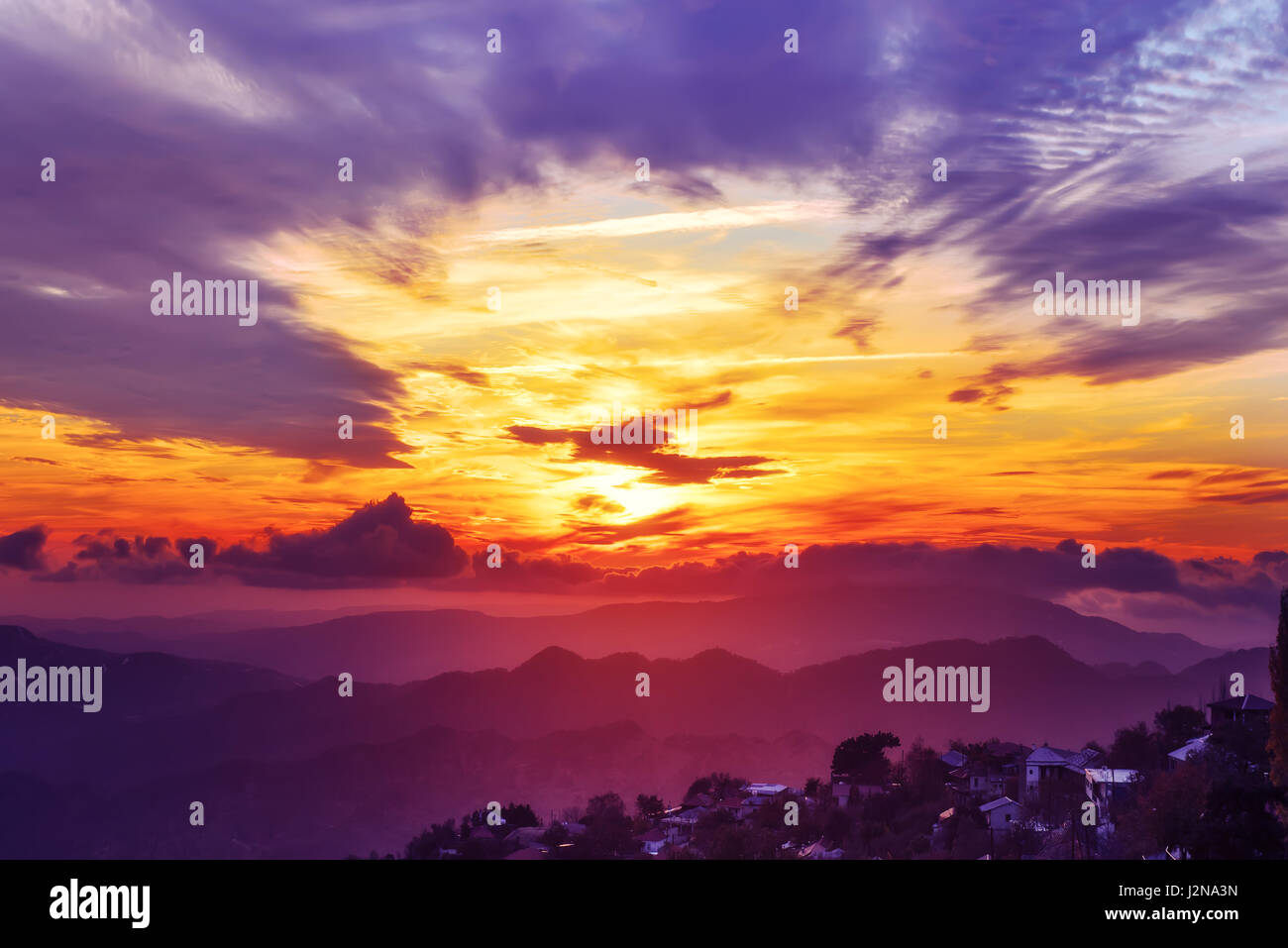 Amazing mountain landscape with colorful vivid sunset on the bright sky ...