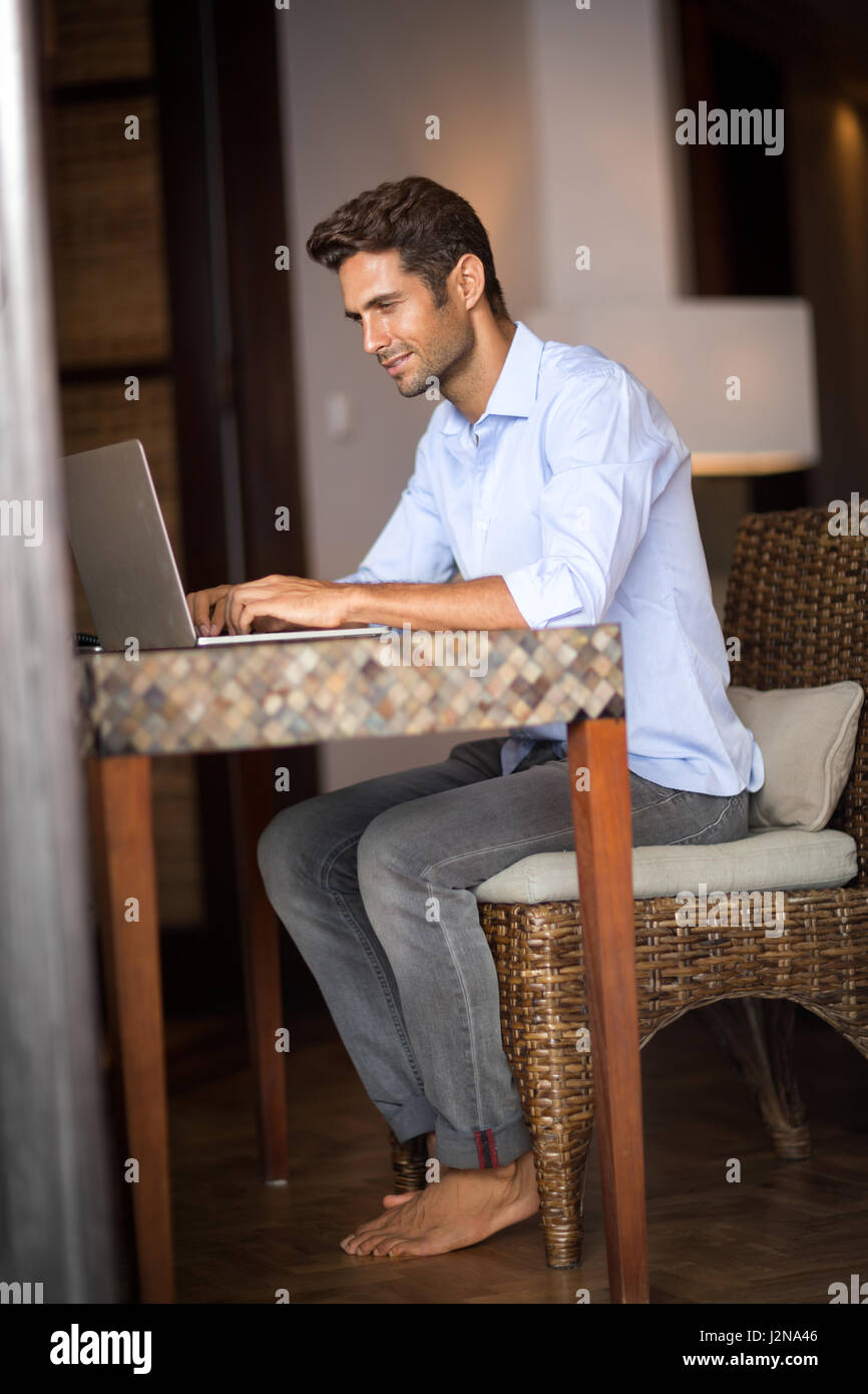 Young guy sitting home barefoot hi-res stock photography and images - Alamy
