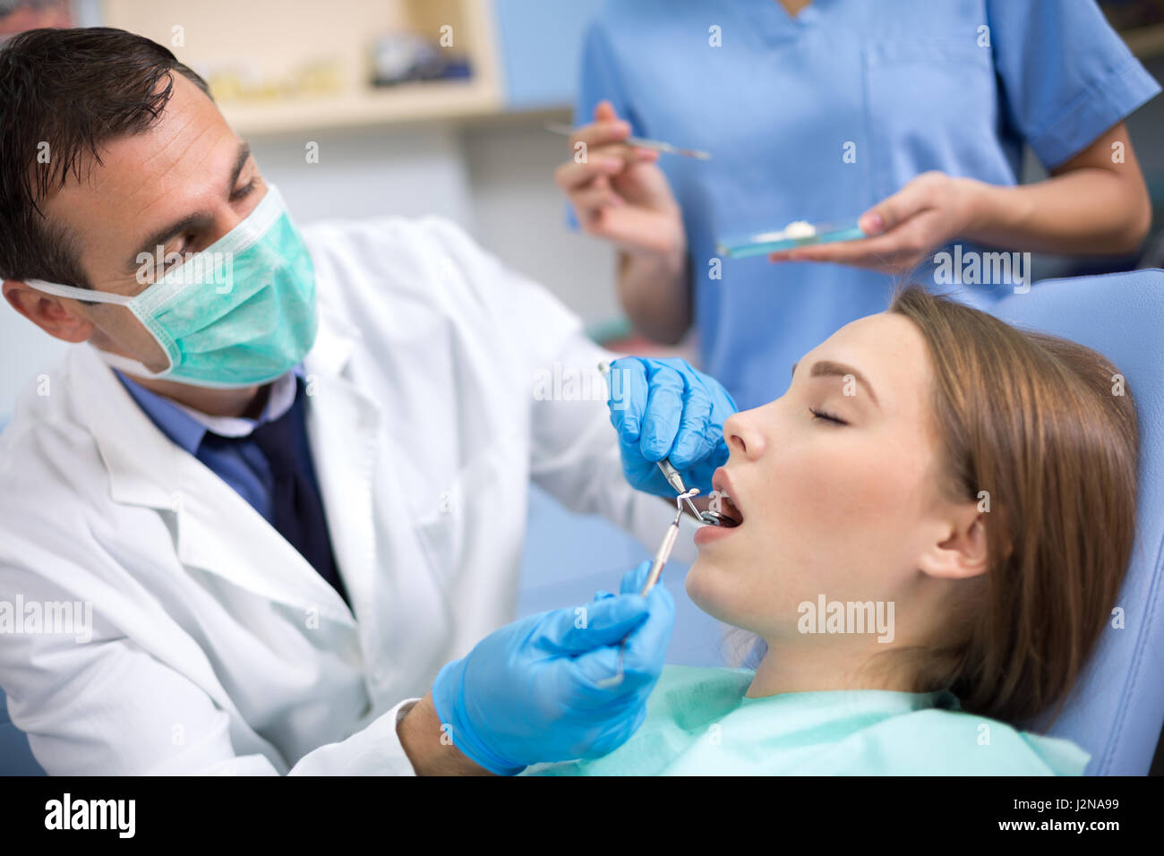 Strpping Tooth Dentist put dental stopping in tooth of girl prepared by dental ...