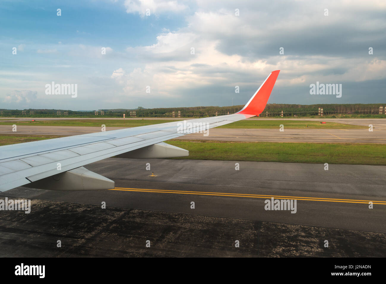 Airplane in landing runway road plane wing blue sky in airport. Stock Photo