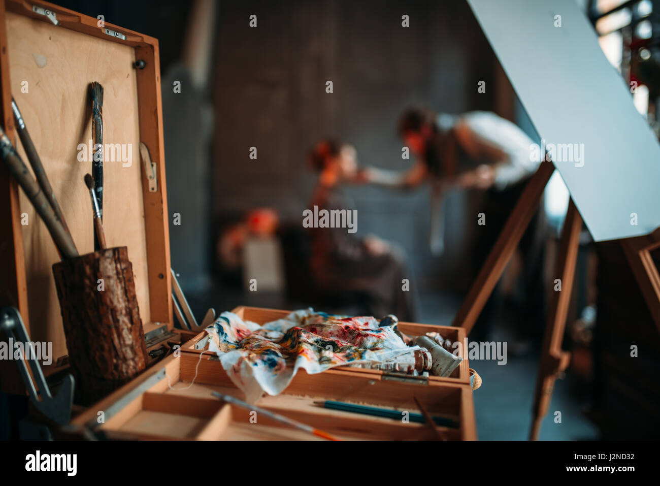 Wooden sketch drawer with drawing tools closeup view. Male painter work