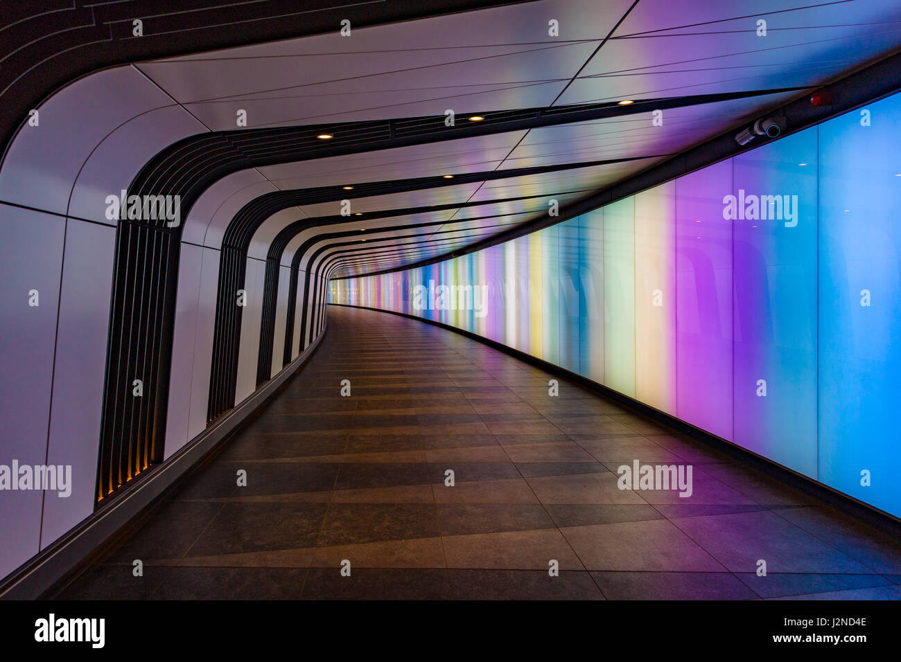 The pedestrian tunnel with a light wall at King's Cross St. Pancras stations in London Stock Photo