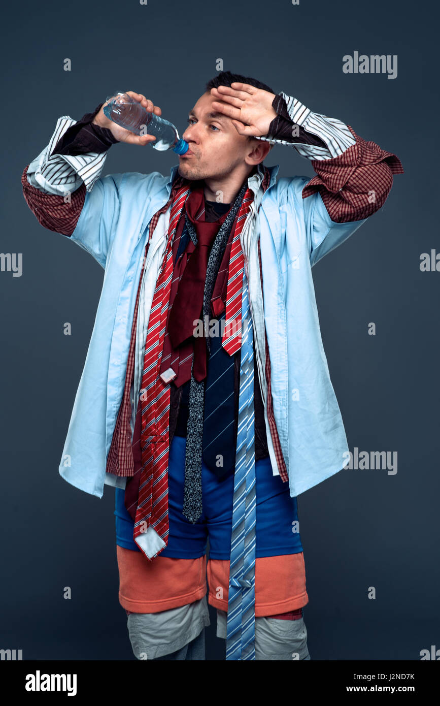 Tired male buyer drink water after clothes sale. Shopping concept