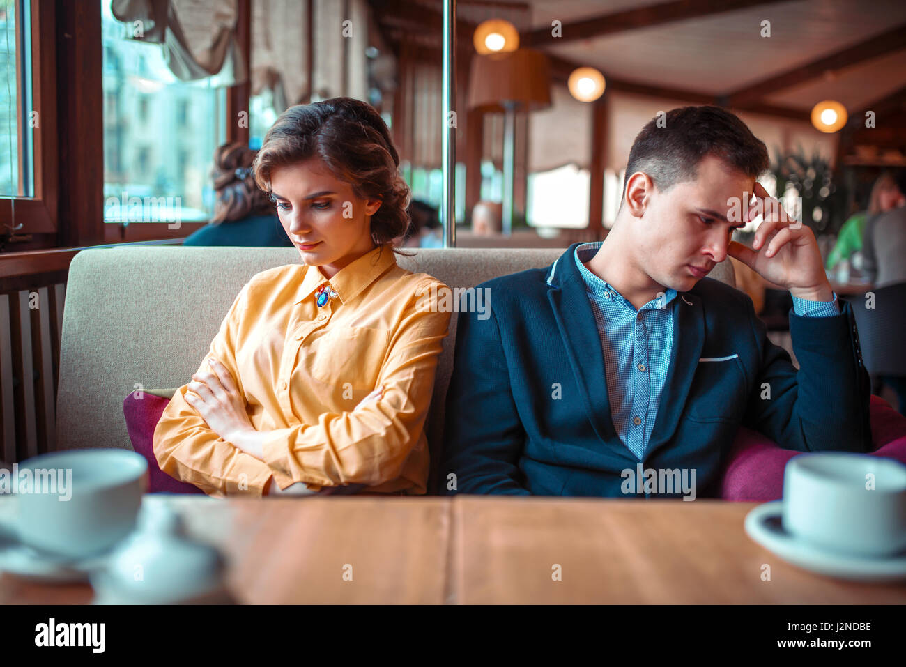 Couple in a bad mood sitting in restaurant. Man and woman relationship  Stock Photo - Alamy, image size:1300x957