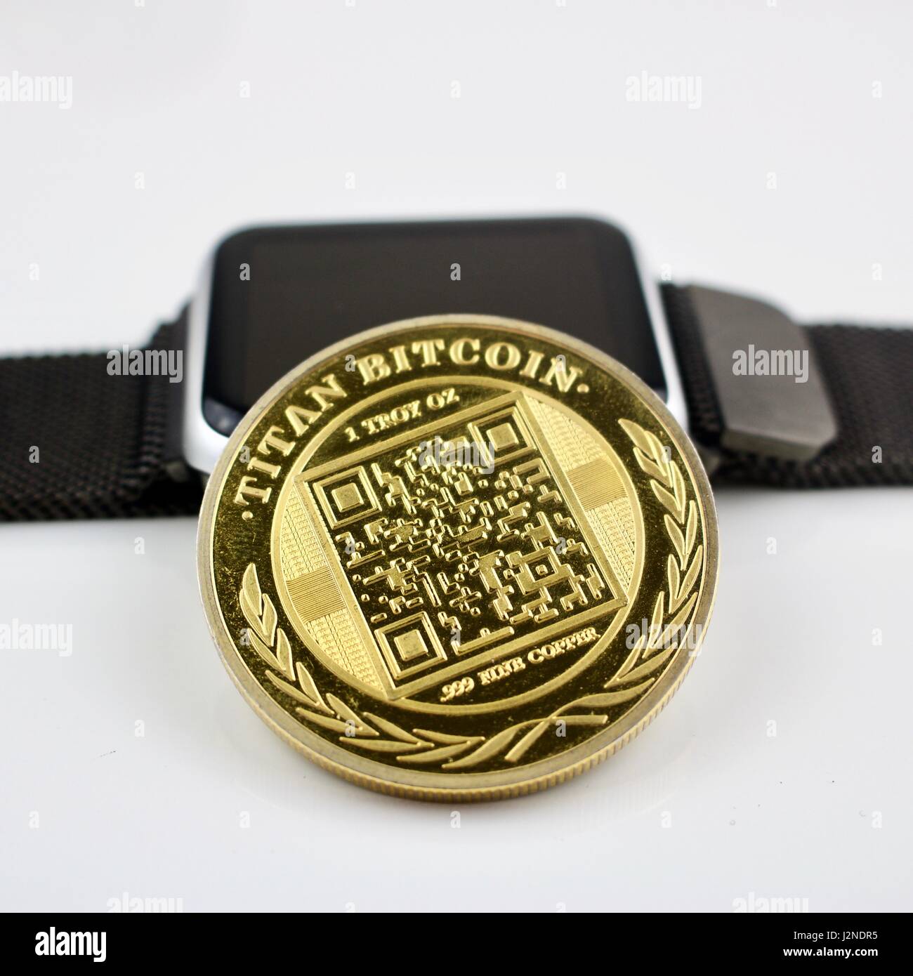 Cryptocurrency physical gold titan bitcoin and black smartwatch Stock Photo  - Alamy