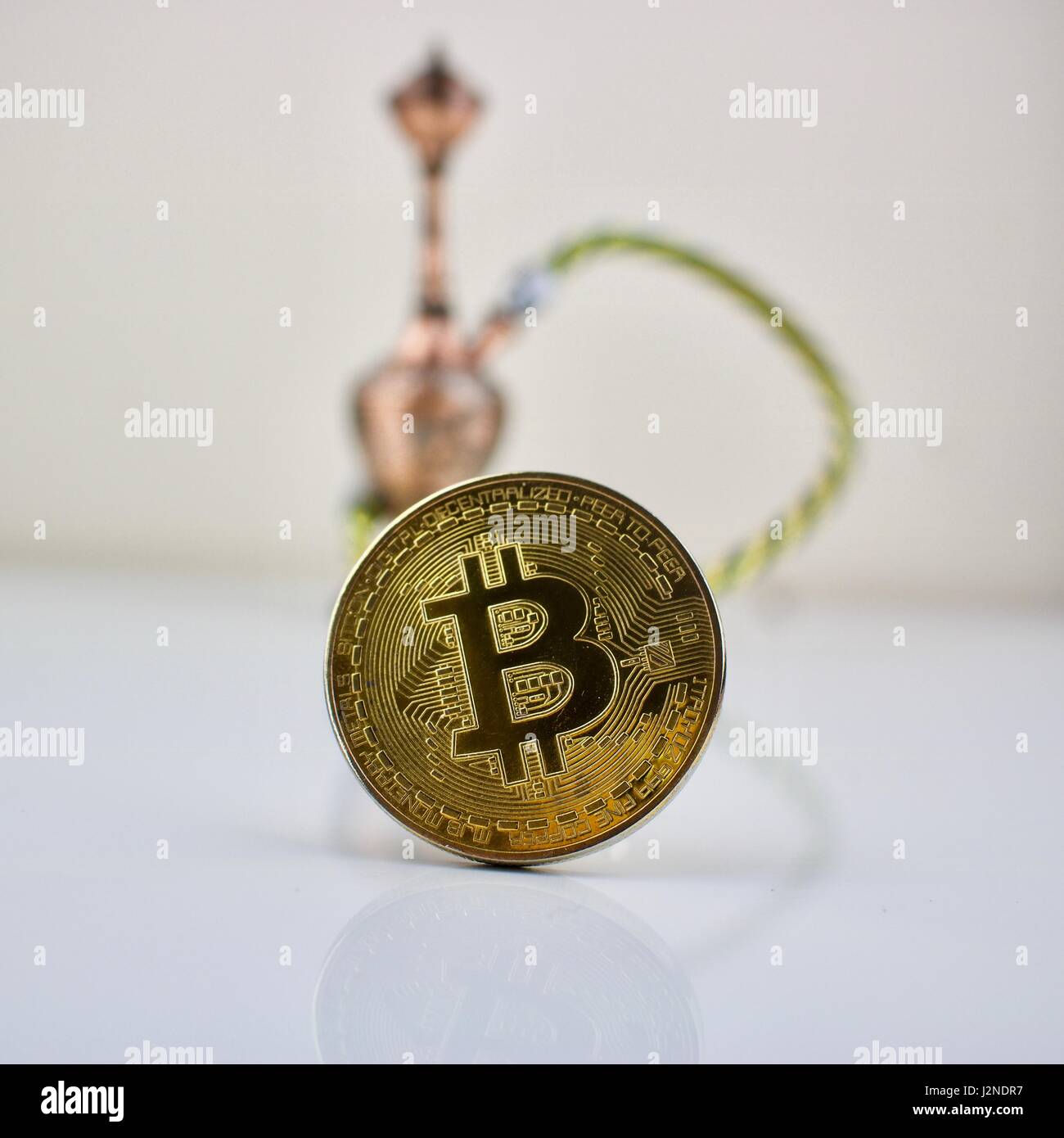 Cryptocurrency physical gold bitcoin coin and small sisha Stock Photo -  Alamy