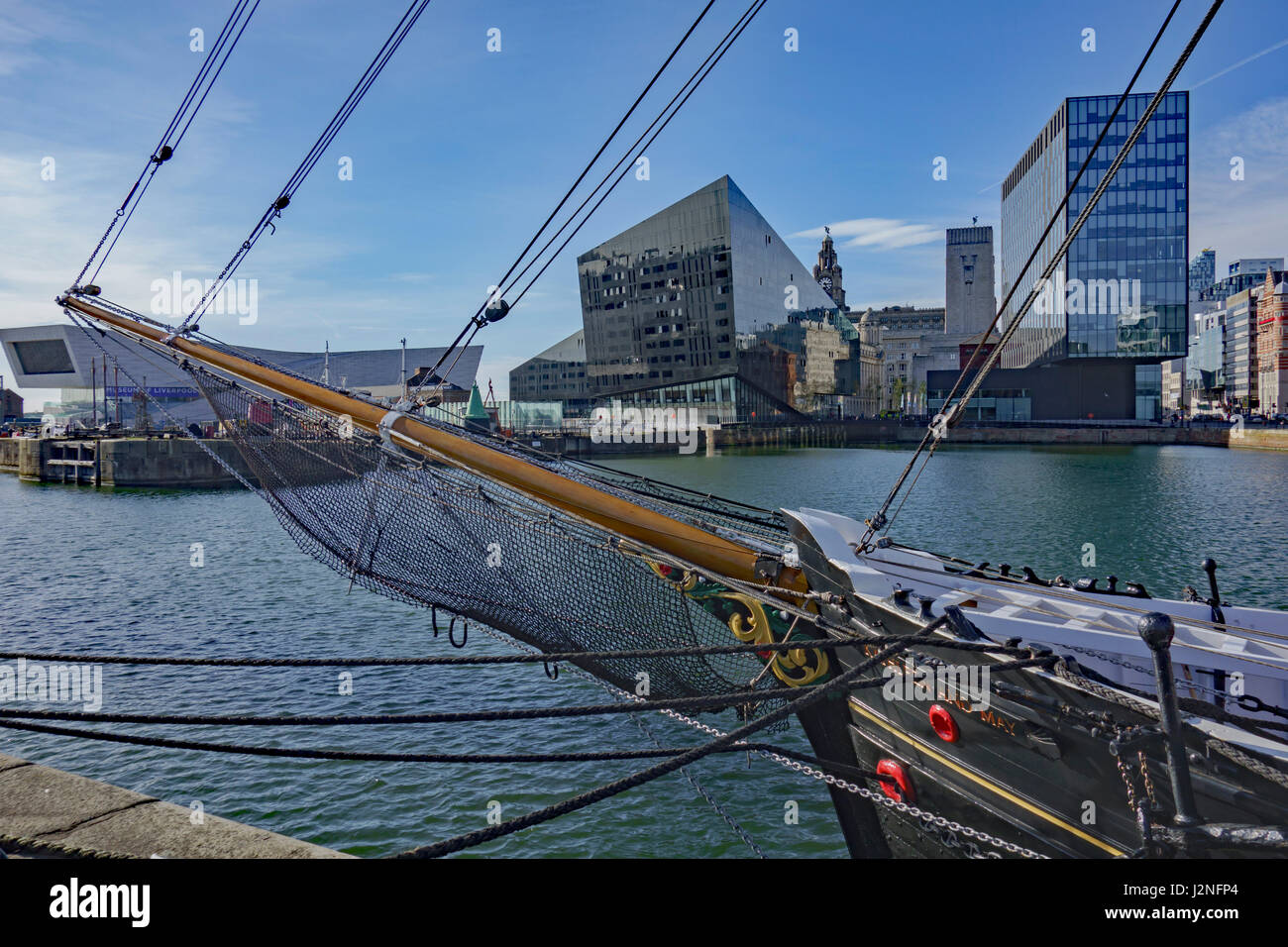 View across Canning Dock, Liverpool, with old sailing ship in foreground. Stock Photo
