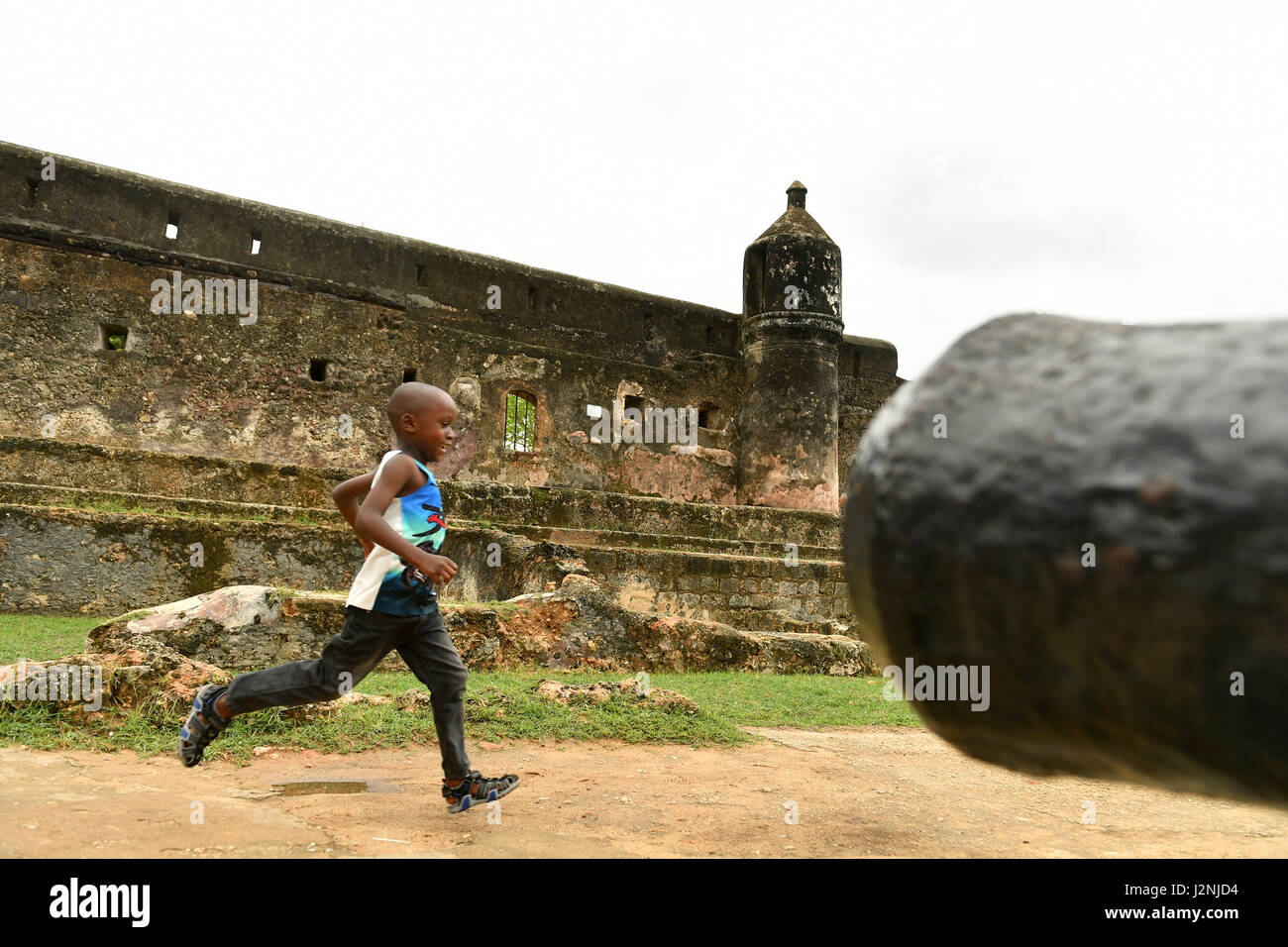 Mombasa, Kenya. 29th Apr, 2017. A boy runs past an old cannon at Fort Jesus in Mombasa, Kenya, April 29, 2017. Located in the Southeastern corner of Mombasa city, Fort Jesus was built by Portuguese colonists between 1593 and 1596. Fort Jesus is one of the most outstanding and well preserved examples of 16th Portuguese military fortifications and the UNESCO added the the fort to World Heritage List as a cultural site in 2011. Credit: Sun Ruibo/Xinhua/Alamy Live News Stock Photo