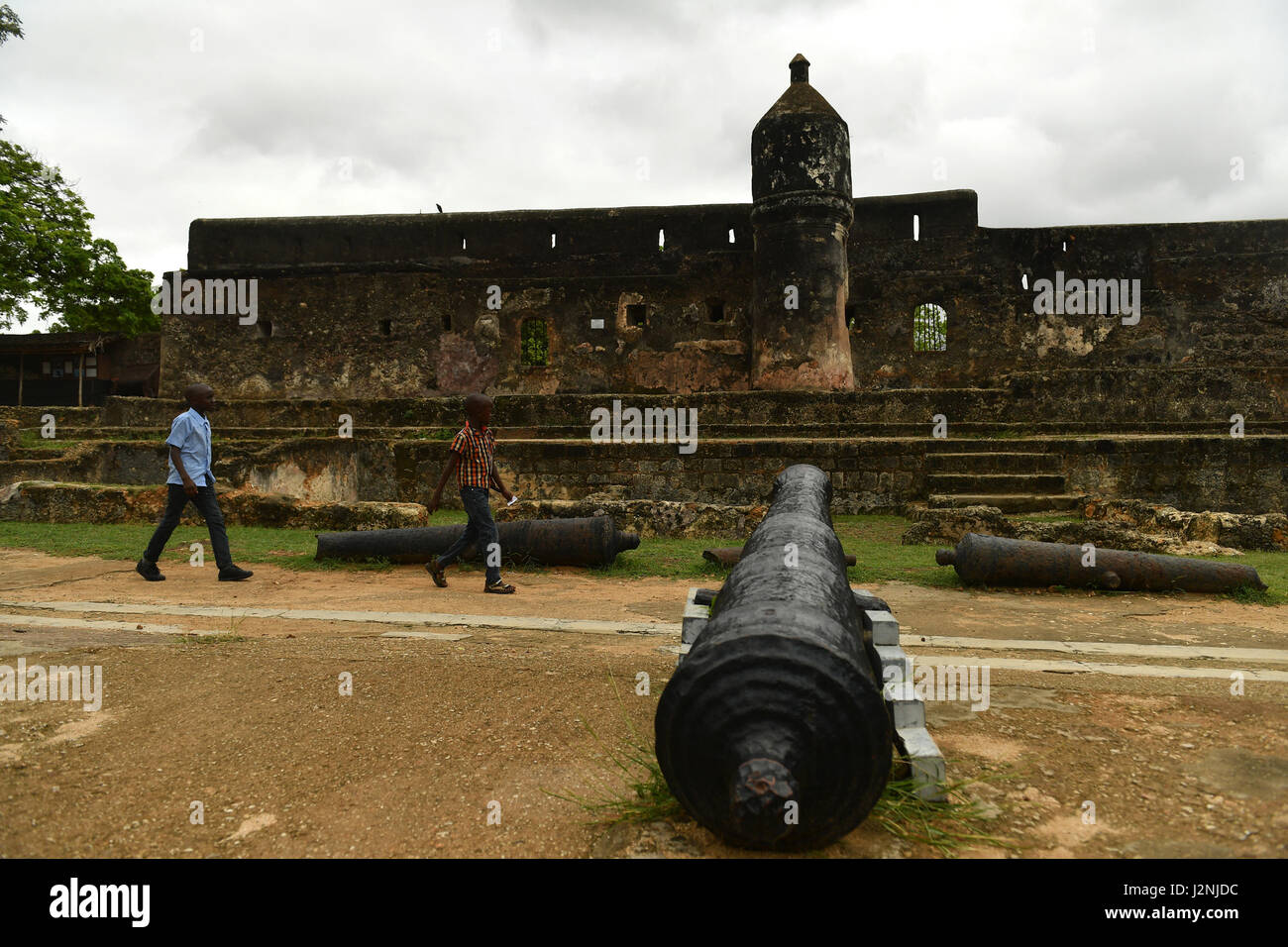 Mombasa, Kenya. 29th Apr, 2017. Two children walk past some old cannons at Fort Jesus in Mombasa, Kenya, April 29, 2017. Located in the Southeastern corner of Mombasa city, Fort Jesus was built by Portuguese colonists between 1593 and 1596. Fort Jesus is one of the most outstanding and well preserved examples of 16th Portuguese military fortifications and the UNESCO added the the fort to World Heritage List as a cultural site in 2011. Credit: Sun Ruibo/Xinhua/Alamy Live News Stock Photo