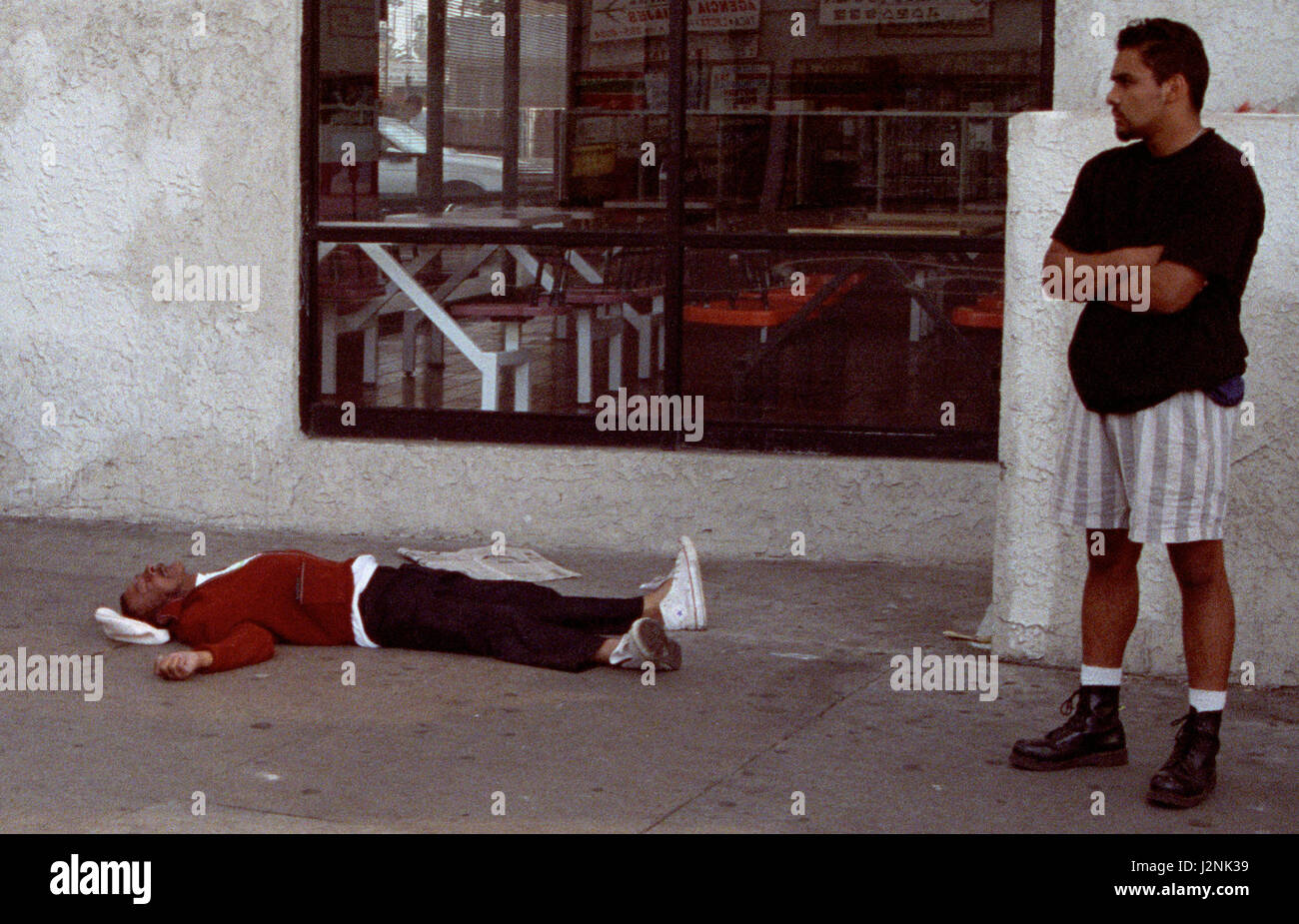 April 29/May 4 1992. Los Angeles CA. Coverage as man lies dead from the Los Angeles riots after the not guilty acquittal of policemen on trial in beating of Rodney King. In total, 55 people were killed during the riots, more than 2,000 people were injured, and more than 11,000 were arrested and $1 billion in property damage. Photos by Gene Blevins/LA DailyNews/ZumaPress. Credit: Gene Blevins/ZUMA Wire/Alamy Live News Stock Photo