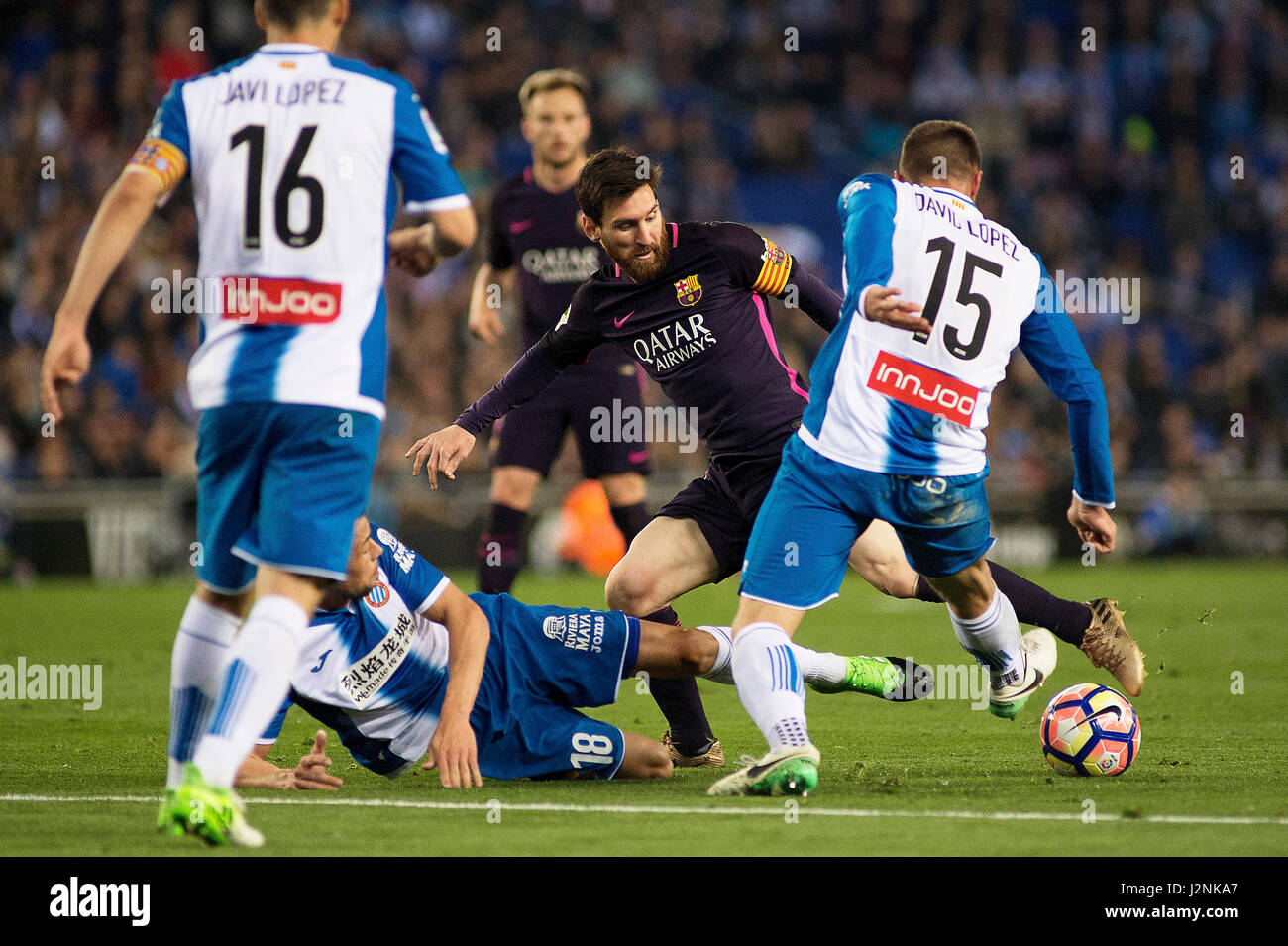 Barcelona, Spain. 29th Apr, 2017. Barcelona's Lionel Messi(2nd R) vies with Espanyol's David Lopez (1st R) and Javi Fuego (2nd L) during the Spanish first division (La Liga) soccer match between RCD Espanyol and FC Barcelona at RCDE Stadium in Barcelona, Spain, April 29, 2017. Barcelona won 3-0. Credit: Lino De Vallier/Xinhua/Alamy Live News Stock Photo
