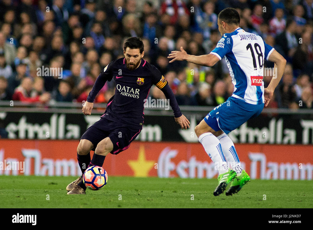 Barcelona, Spain. 29th Apr, 2017. Barcelona's Lionel Messi(L) vies with Espanyol's Javi Fuego during the Spanish first division (La Liga) soccer match between RCD Espanyol and FC Barcelona at RCDE Stadium in Barcelona, Spain, April 29, 2017. Barcelona won 3-0. Credit: Lino De Vallier/Xinhua/Alamy Live News Stock Photo
