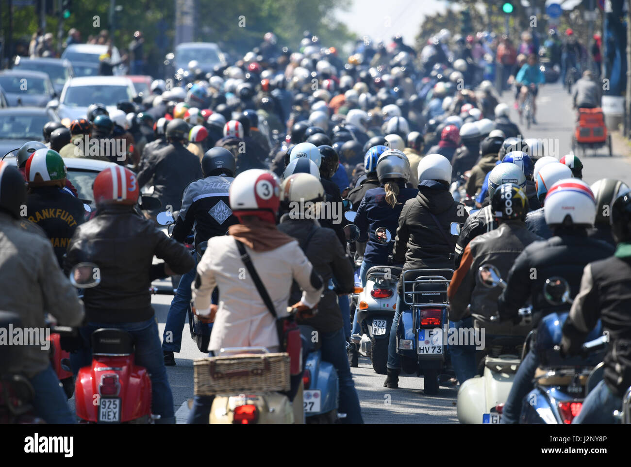 dpatop - Vespa 'friends' open the two-wheelers' season  with the 'Anrollern' (lt.starting to roll) in Frankfurt, Germany, 20 April 2017. Clubs from all over the Rhine-Main area meet for a 50-kilometer-long trip through Frankfurt and the surrounding area. The traditional 'roll-off' takes place on the second weekend in October. Photo: Arne Dedert/dpa Stock Photo
