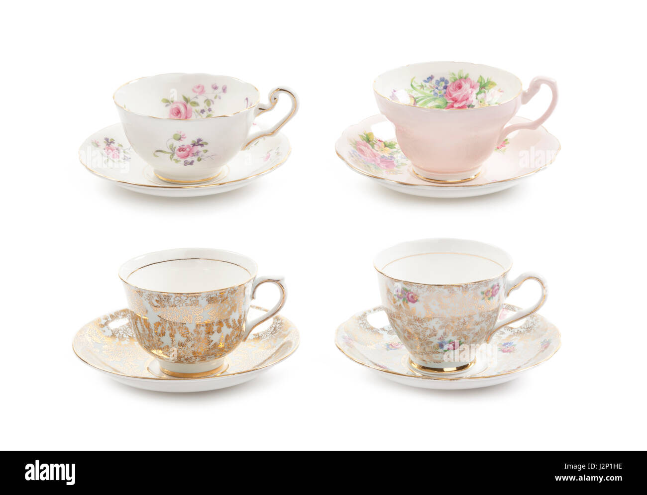 High resolution close-up of four beautiful antique tea cups with saucers isolated on a white background. Stock Photo