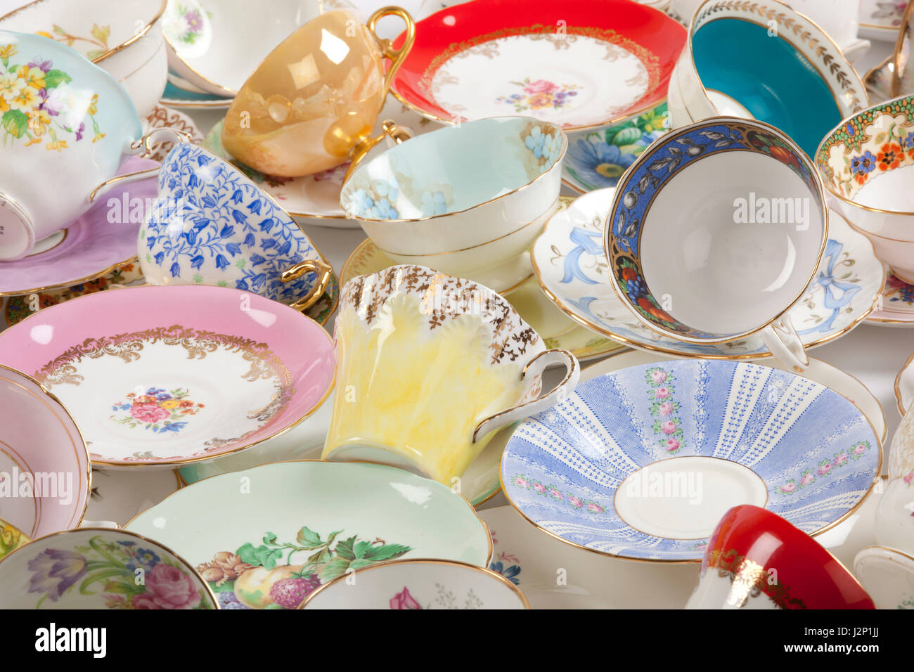 High resolution close-up of a beautiful antique tea cups and saucers collection, isolated on a white background. Stock Photo
