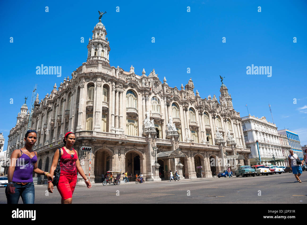 HAVANA - JUNE 14, 2011: Cuban women cross the intersection in front of