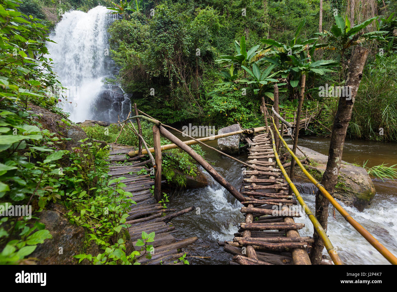 Makeshift wooden bridge pathway to a waterfall in northern Thailand Stock Photo
